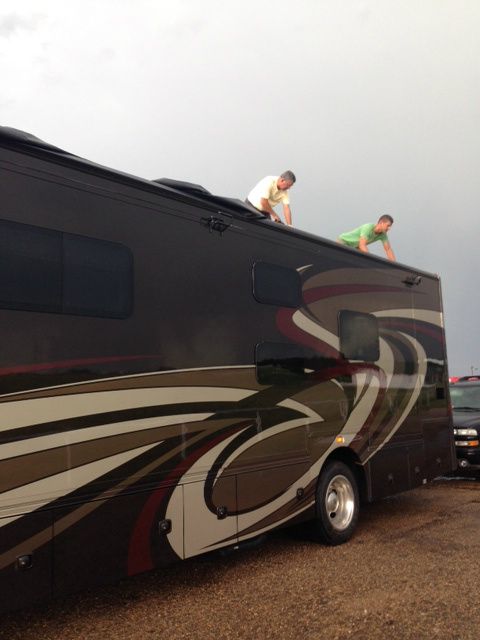 Shawn and his dad on the roof of the RV assessing the damage. They ended up cutting off the entire canvass.