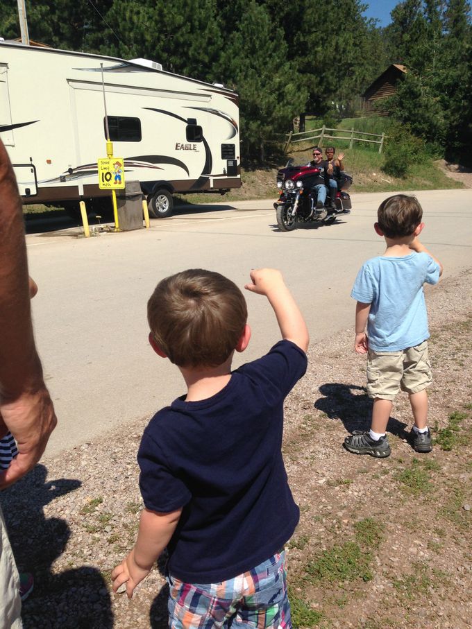 Jude waiving at all of the motorcycles.